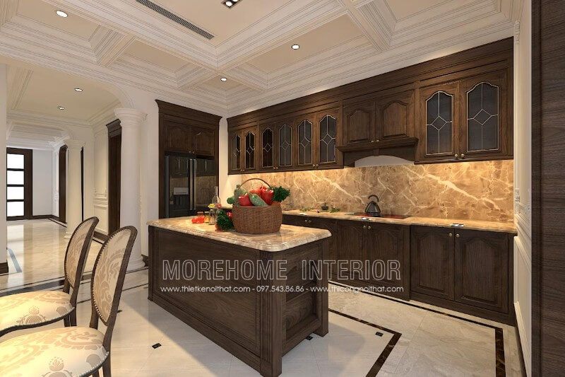 Tủ bếp gỗ óc chó tân cổ điển được thiết kế kết hợp với bàn đảo và chất liệu đặt giữa để tạo sự cân bằng cho không gian và cung cấp nhiều tiện nghi hơn cho người nội trợ.